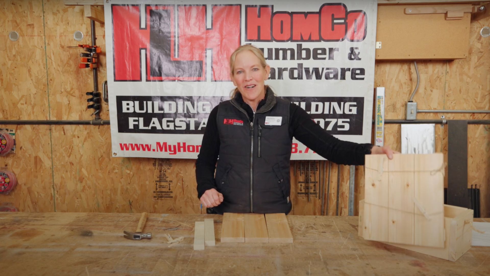 woman holding wooden message board